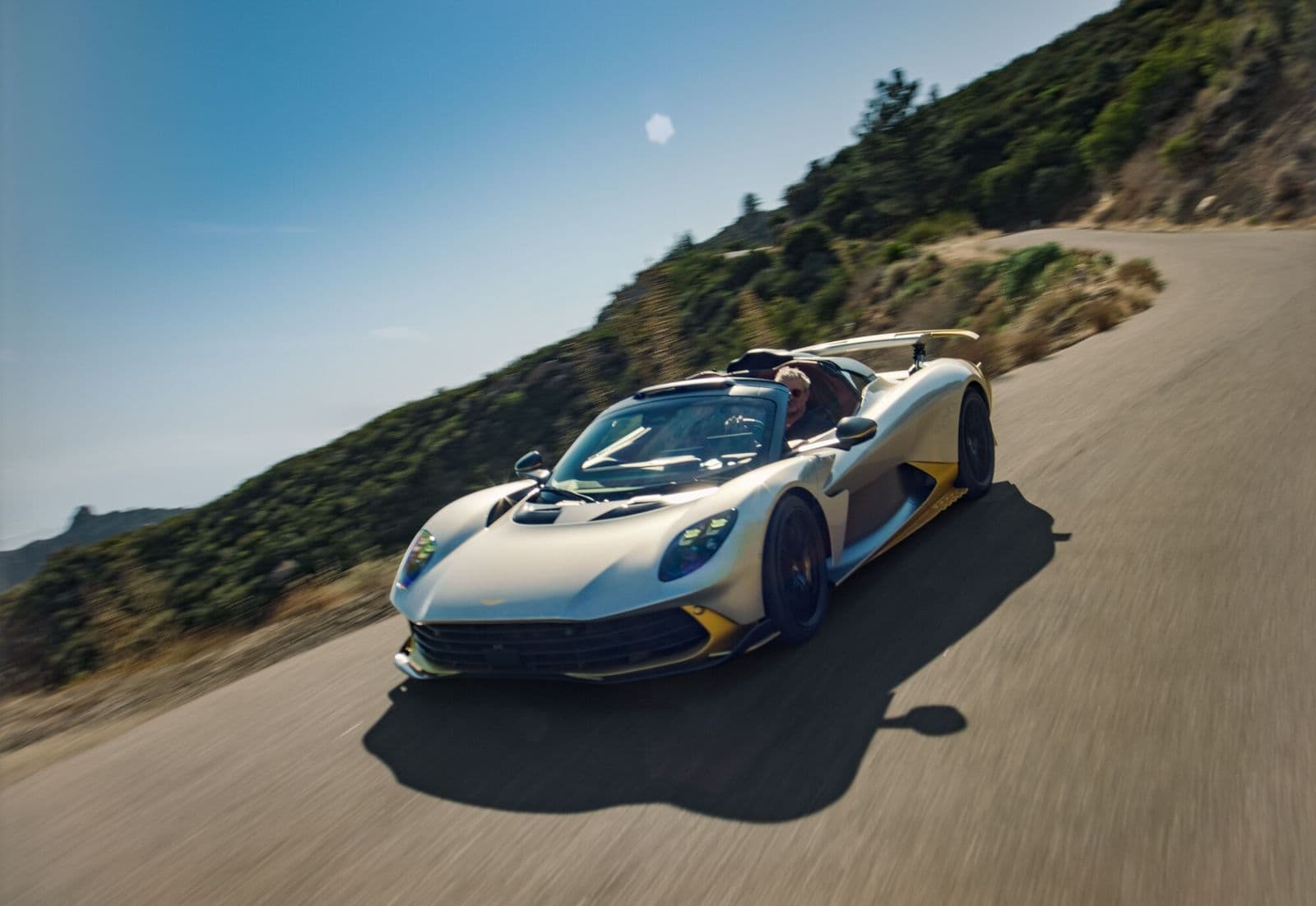 aston martin valhalla spider silver front three quarter view on a mountain road