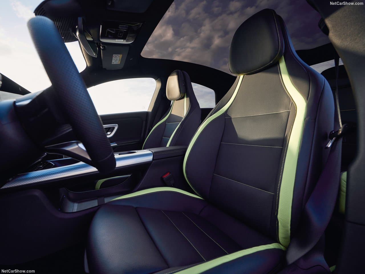 Front seats of the new CLA, dark leather trimmed with lime green, under the panoramic glass roof
